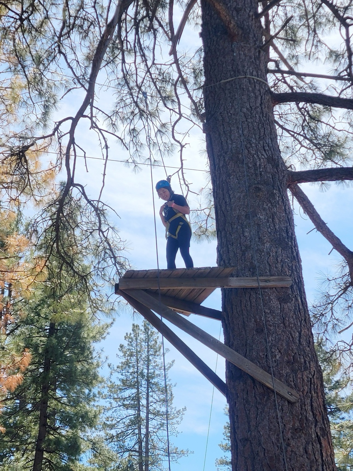 A student on the high ropes course platform