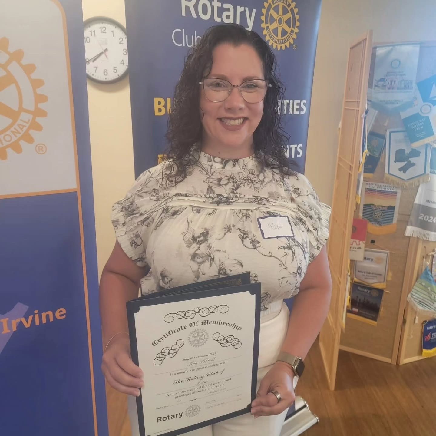New member Kali Ashford holding her Rotary Club of Irvine membership certificate