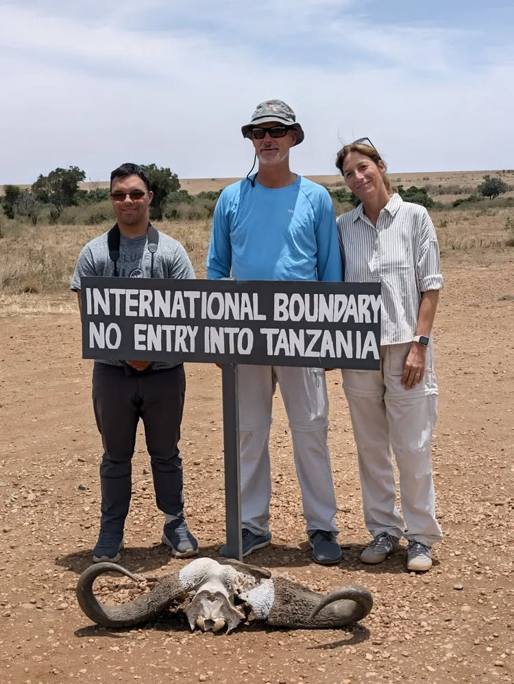 Rotarians at the Kenya and Tanzania border sign on safari